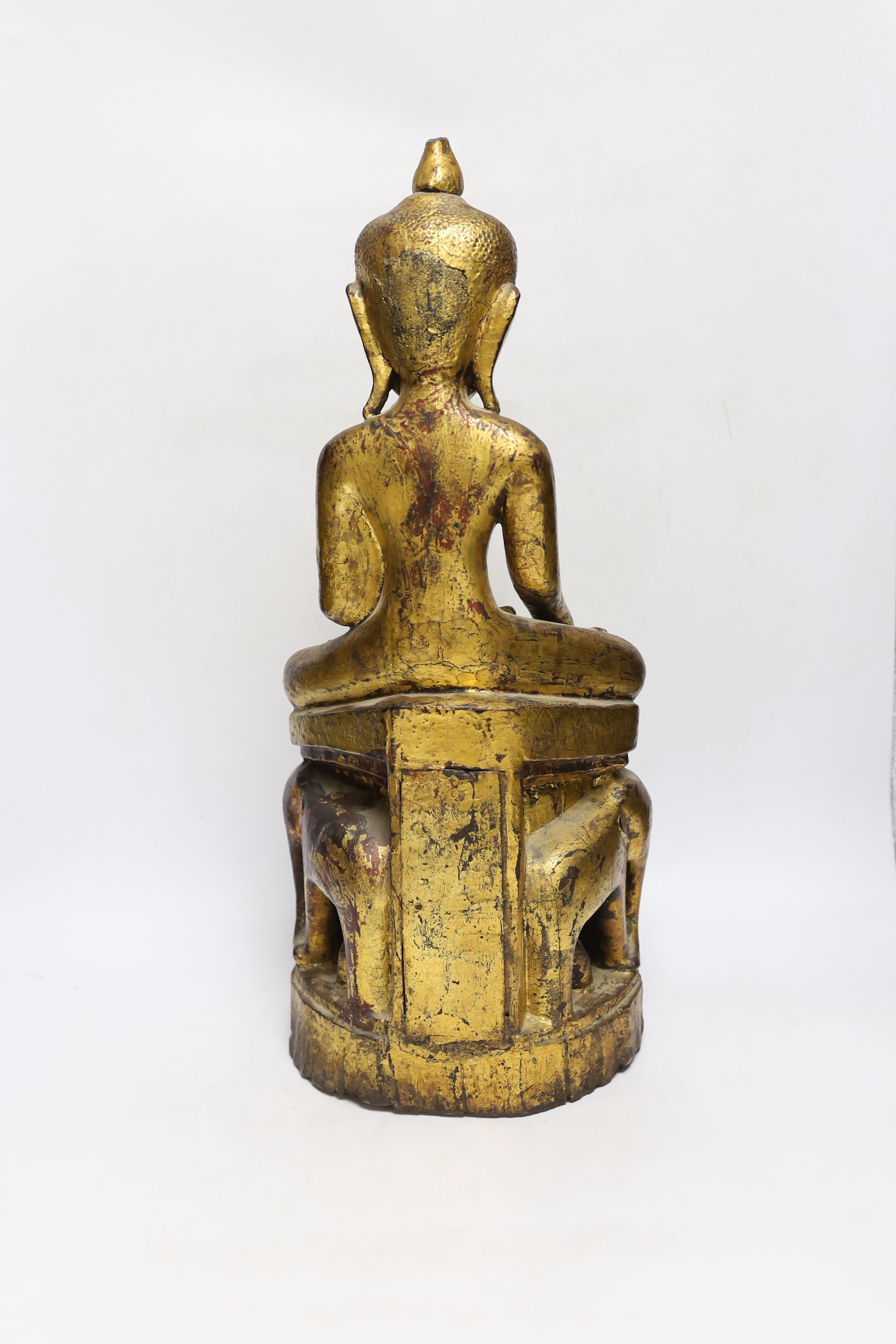A 19th century Burmese or Thai giltwood figure of Buddha, on an elephant throne, 52cm